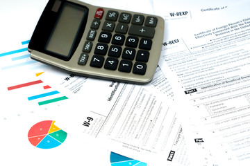 tax forms with calculator and colorful charts