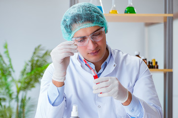 Young doctor working on blood test in lab hospital