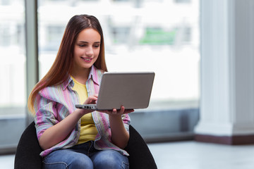 Young girl surfing internet on laptop