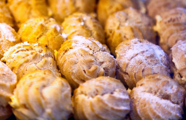 Profiteroles, sweet dessert stuffed with powdered sugar