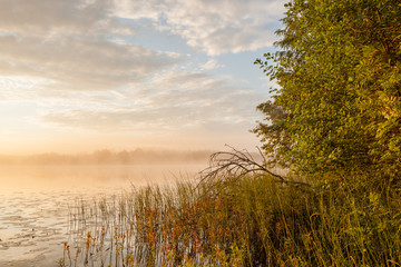 Sunrise at foggy lake