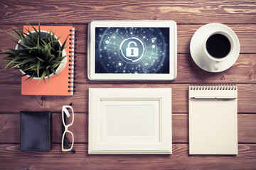 Web security and technology concept with tablet pc on wooden tab