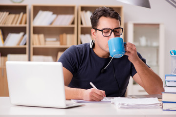 Young student drinking coffee from cup