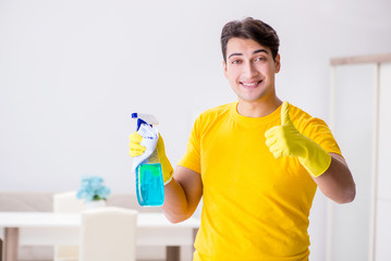 Man husband cleaning the house helping his wife