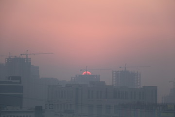 Fototapeta na wymiar Sunset behind construction site 