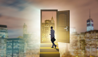 Businessman walking towards open door