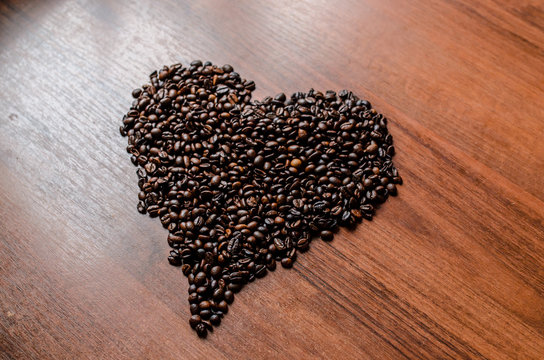 The coffee beans in the shape of a heart. © fotofrol