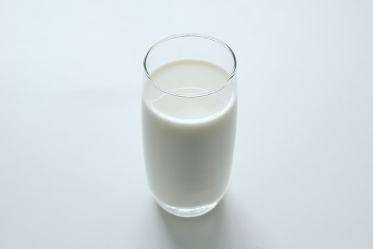 A glass of milk on the white background.