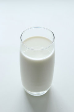 A glass of milk on the white background.
