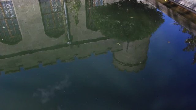 The medieval castle is reflected in the pond