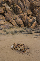 Fototapeta na wymiar Stone fire pit at a camp site in southern California's Mojave desert.