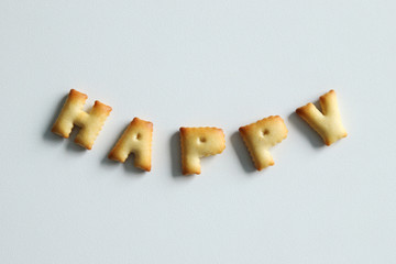 An inscription from the cookies on the white background. Text – happy.