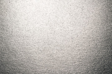 Background of silver paper with overflow and glare.