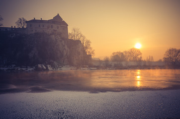 Fototapeta Krakow, Poland, Tyniec abbey in the morning over frozen Vistula river, obraz