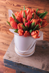 bunch of fresh orange tulips on a chair