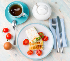 Served meal of sandwich, egg, tea, topview