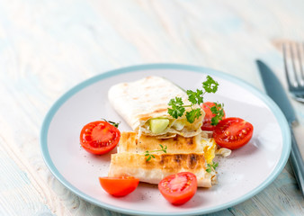 Brunch containing vegan sandwich and cut tomatoes