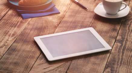 White tablet with copy space on a wooden table
