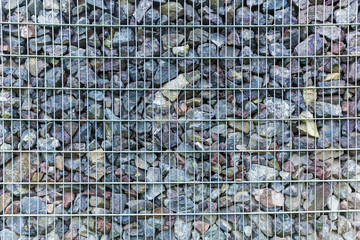 Fototapeta premium fence from the pieces of granite and metallic grates