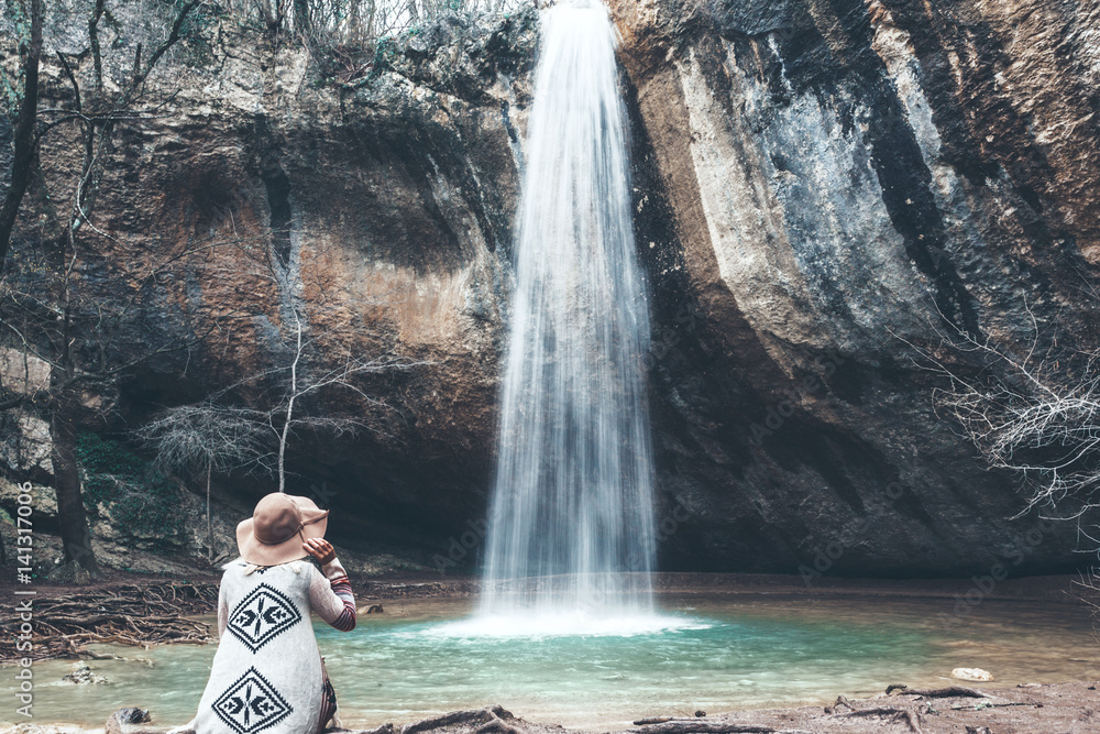 Poster human standing by the waterfall