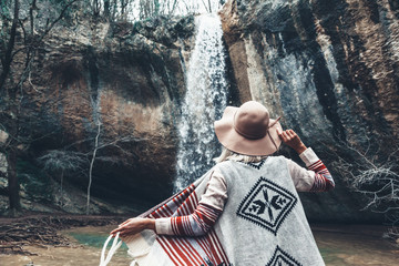 Human standing by the waterfall