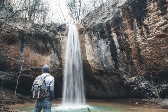 Human standing by the waterfall