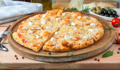 Pizza "Four cheeses" with tomato sauce, artichoke hearts, olives, Parmacotto, fresh mozzarella, parmesan
