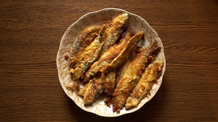 Fried fish in the plate on the table