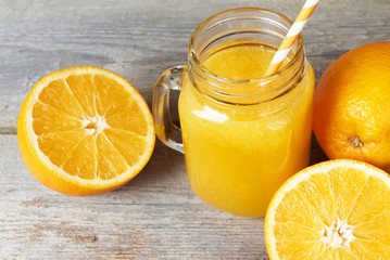 Naklejka na ściany i meble Glass of orange juice and orange fruit