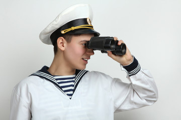 sailor looking through binoculars