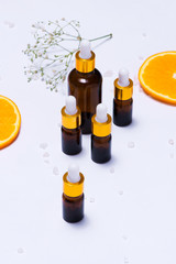 Branding mock-up. Natural essential oil, Cosmetic bottle containers with orange slices.