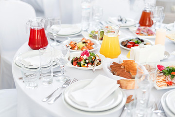 Restaurant table with food. Tasty appetizers, salads. Different meals for the guests on the wedding table