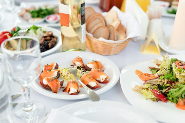 Restaurant table with food. Tasty appetizers, salads. Different meals for the guests on the wedding table