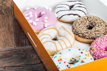 glazed donuts with different fillings in the box