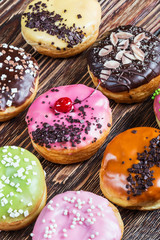 Glazed donuts with different fillings on a wooden table