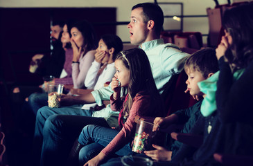 Group of people watching exciting movie