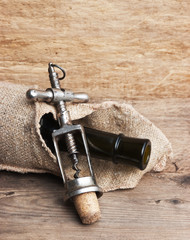 Old corkscrew and bottle of wine