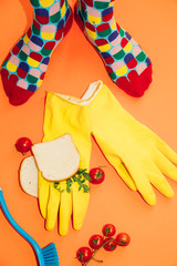 colorful socks,gloves, toast, tomatoes in a orange background, pop concept still life
