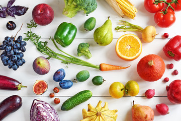 Rainbow colored fruits and vegetables on a white table. Juice and smoothie ingredients. Healthy eating / diet concept.