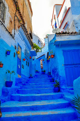 Fototapeta na wymiar street in old Medina of the city of Shefshauen, Morokko. Bright saturated blue color