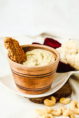 Cashew sauce, raw vegan cheese from nuts with carrot cracker