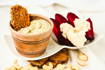 Cashew sauce, diary free cheese from nuts with carrot crackers and vegetables