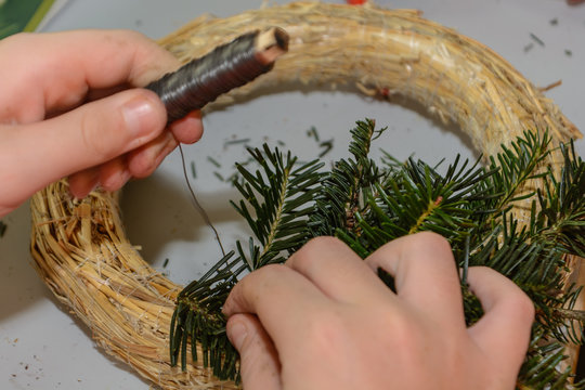 Person bindet Adventskranz
