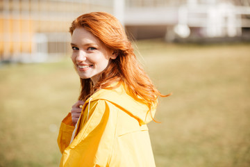 Portrait of a friendly pretty ginger hair girl in coat