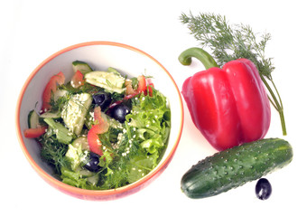 Vegetable salad of cucumbers, red pepper and black olives with sesame seeds