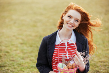 Girl with long hair holding easter picnic basket