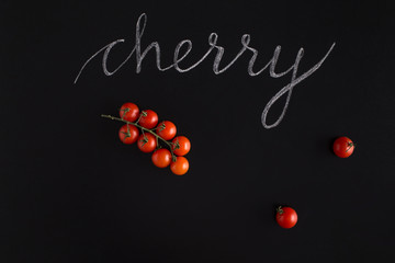 Fresh red cherry tomatoes with the inscription