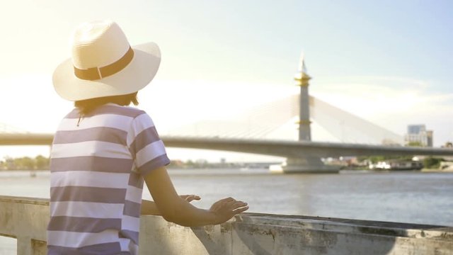 Asian woman tourist using mobile smart phone with Tower Bridge background