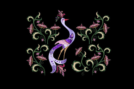 Black background with embroidered stylized birds among branch with flowers and twisted leaves