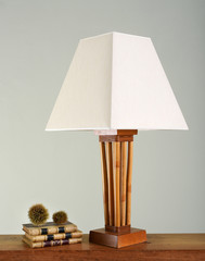 Stack of books next to vintage lamp
